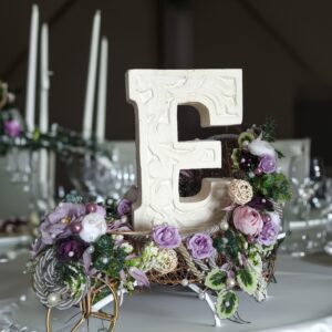 floral stand decoration with personalized carved alphabet